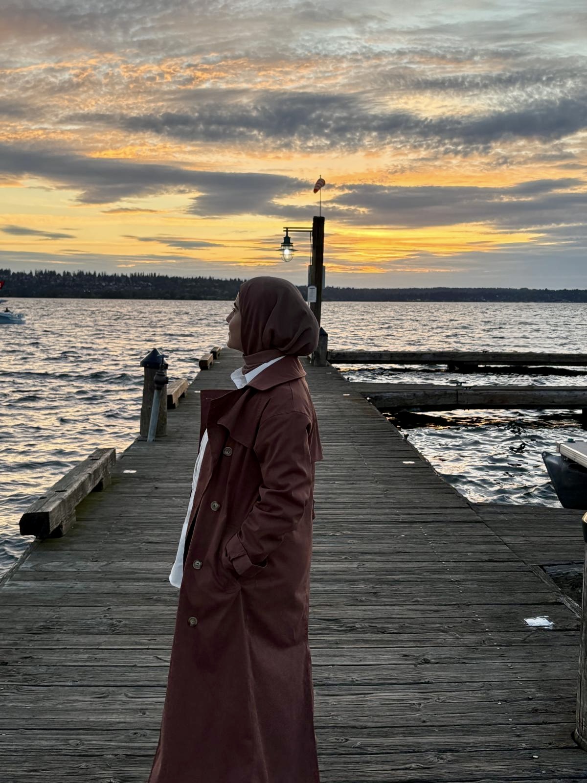 Hiba standing by the water at sunset