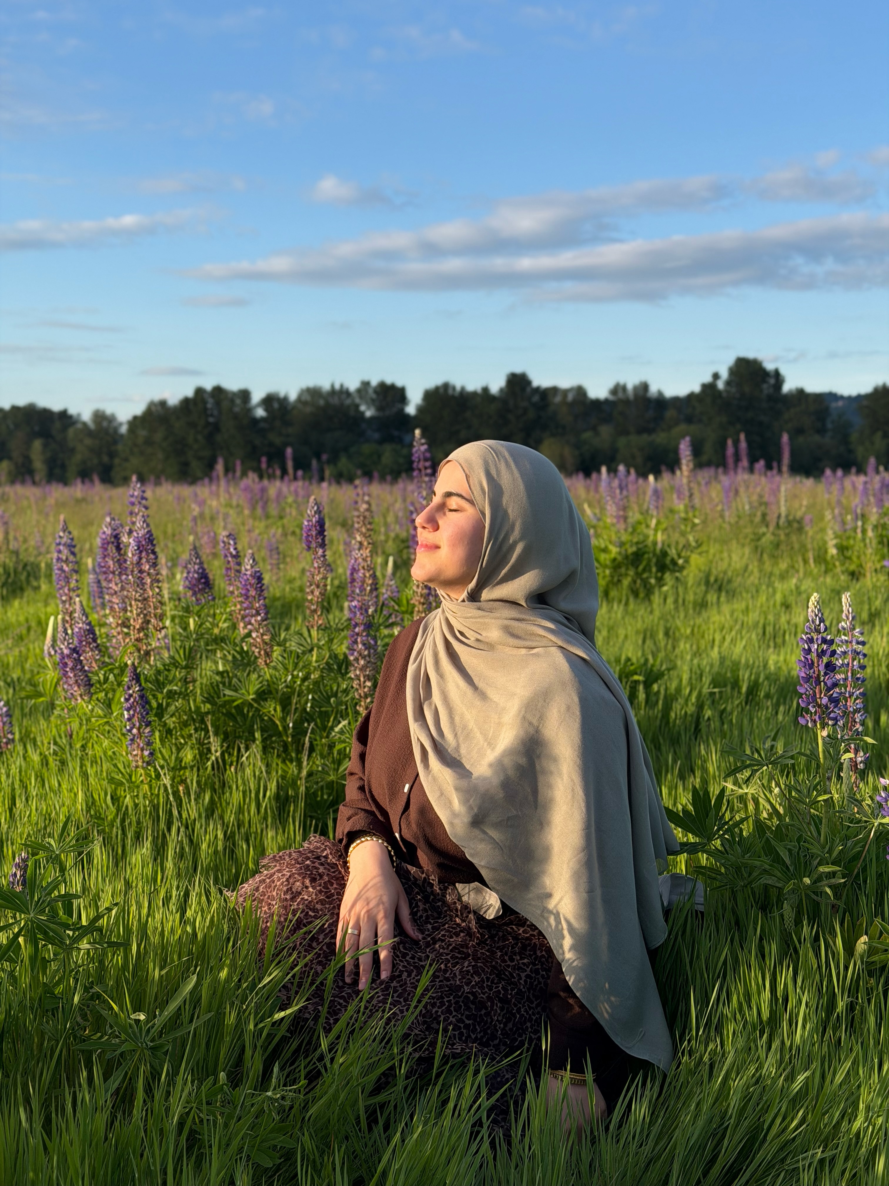 Hiba standing in a field of flowers